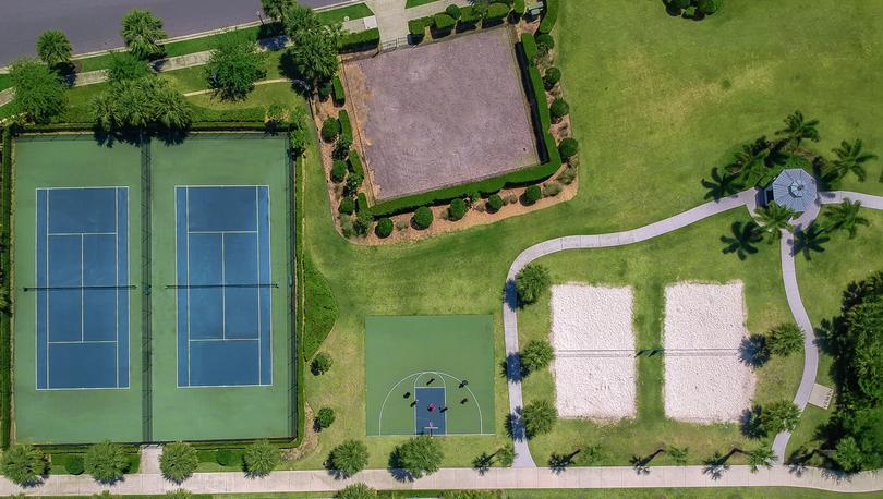 Drone shot of multiple sports courts for tennis, basketball and sand volleyball. 