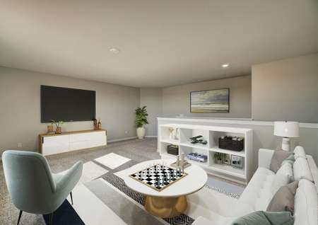Staged game room with white couch, white cabinet and televsion.