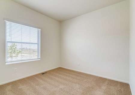 Spare bedroom with a window, carpet and white walls in the Chatfield floor plan.