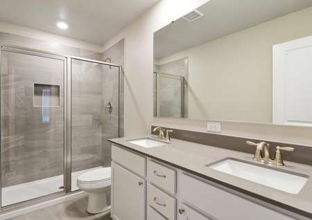 Master bathroom wtih dual sink vanity and a step-in shower