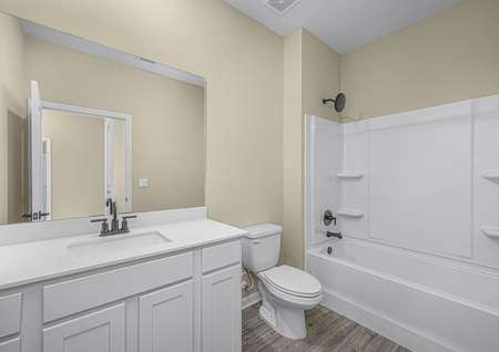 The spare bathroom has a large vanity that is ready for all of your guests