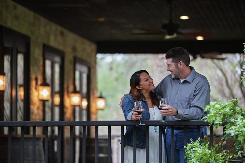 Couple enjoying wine on a covered patio