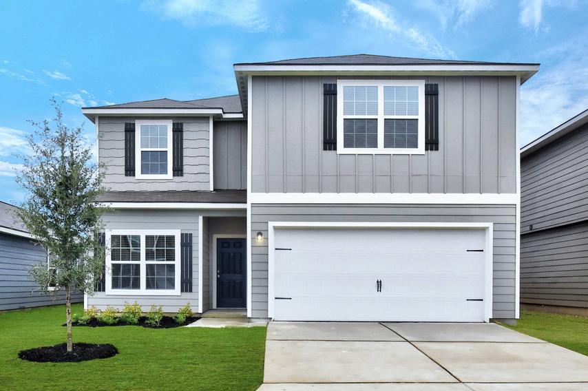 Travis finished house with two stories, grey siding with dark grey shutters, and white two car garage