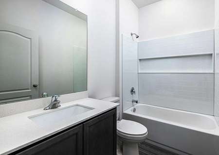 Spare bathroom with large countertop space and a soaker tub.