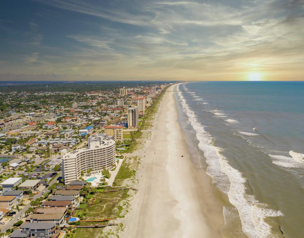 Jacksonville, Florida beach during pandemic lockdown with no beachgoers, condos and apartments, and rolling waves
