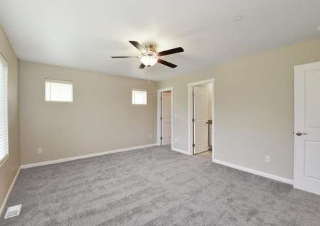 Master bedroom with carpet and a ceiling fan