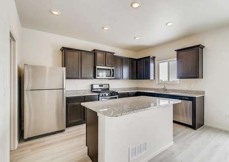 Roosevelt kitchen with stainless steel appliances, wood-like flooring, granite countertops