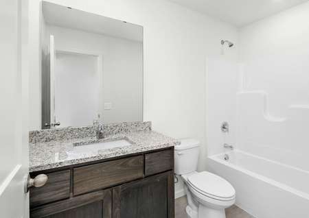 The second bathroom has a large vanity