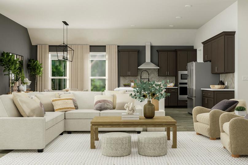 Rendering of the open floor plan in the
  Hudson. A spacious living room with sectional couch and two armchairs is in
  front of the kitchen and dining areas.