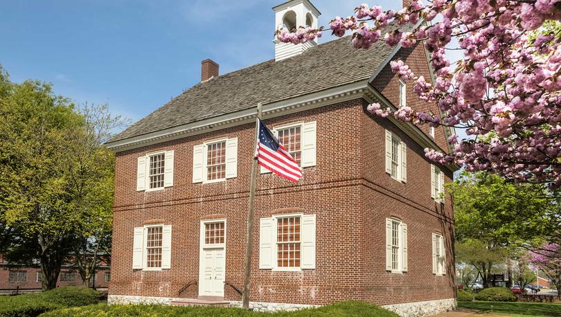 Colonial Court House in York, Pennsylvania two-story brick house with landscape yard and American flag on pole