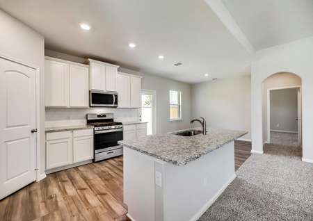 The kitchen offers beautiful, white cabinetry and a full suite of stainless steel appliances.