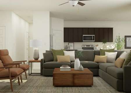 Rendering of the living area complete
  with a large sectional and accent chairs with a view of the kitchen in the
  background.
