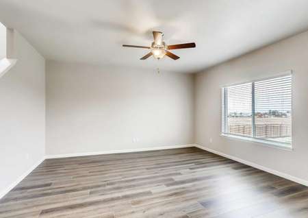 Mesa Verde living room with brown ceiling fan, wood like floors, and grey walls with white trim