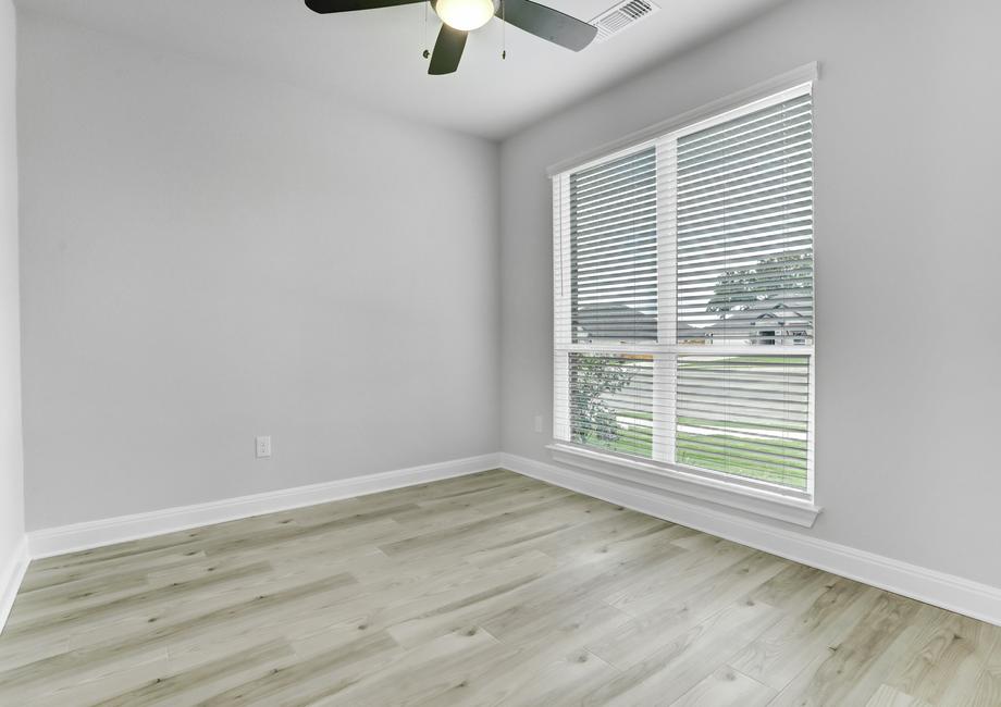 Study located off the entry with large windows, allowing for a bright, open space.