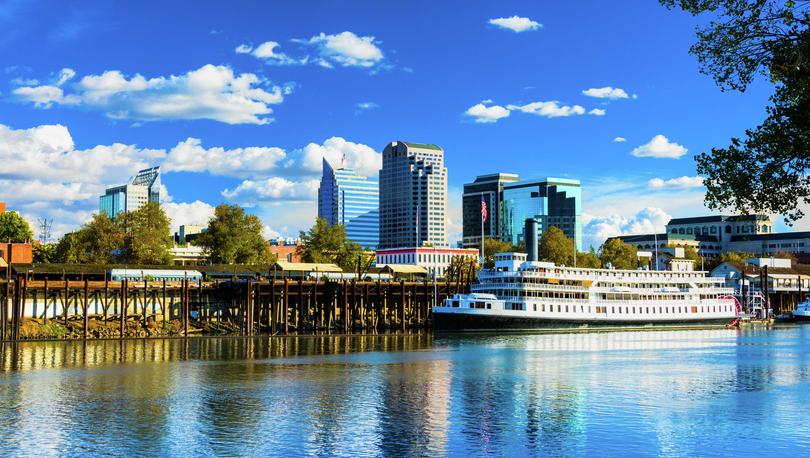 Sacramento, California Delta King riverboat on the Sacramento River showing the city's skyline in the background