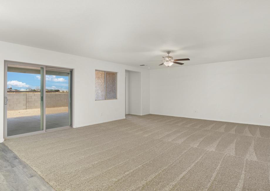 Expansive family room with a ceiling fan provides the perfect space for game nights.