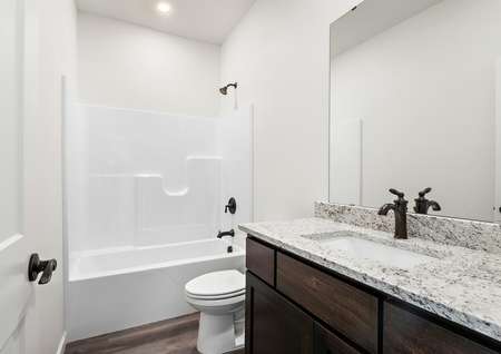 The guest bathroom has a large vanity for your guests to get ready