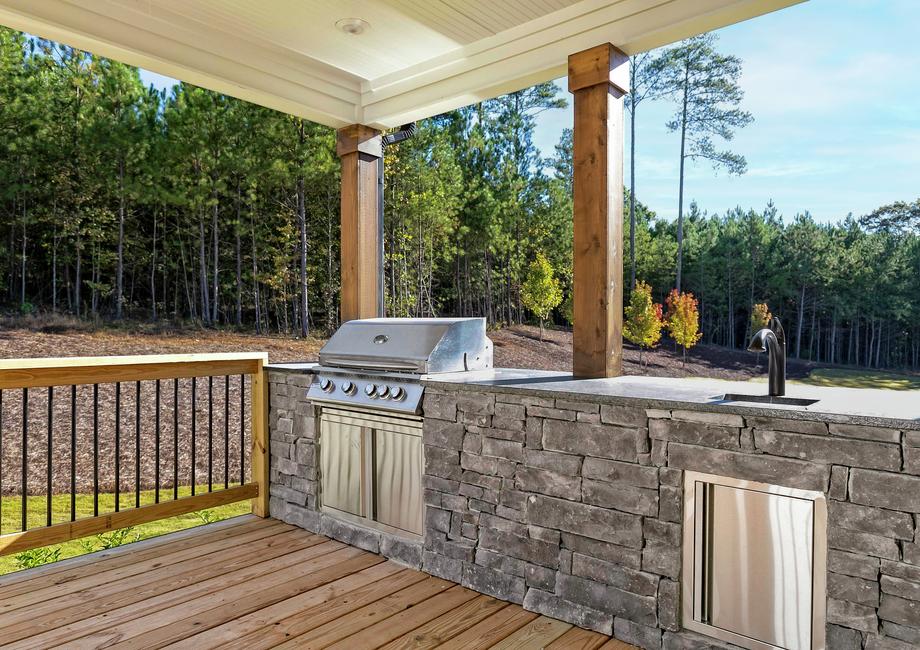 Covered outdoor kitchen with grill.