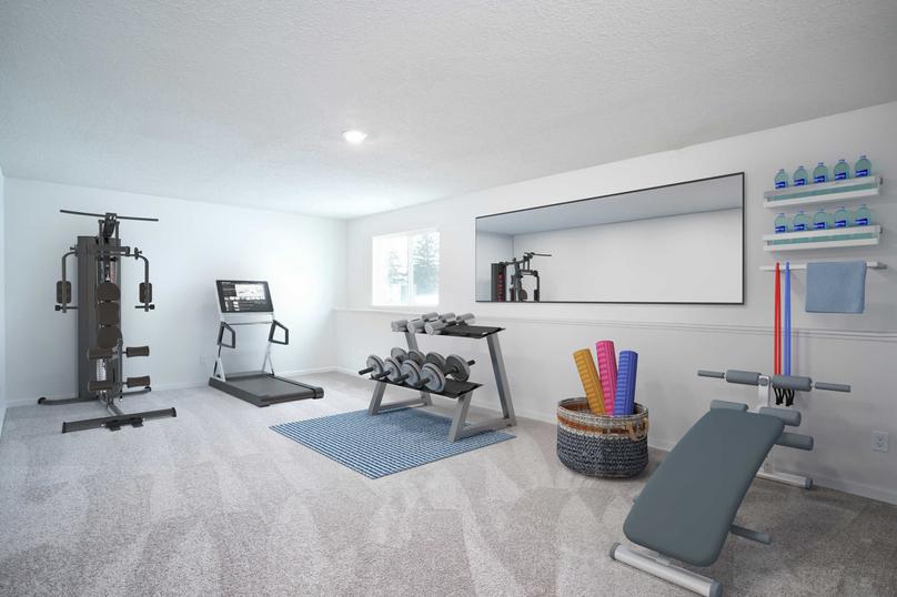 Scott fitness room completed with blue lifting bench, complete barbell weight set, and modern treadmill on the back wall