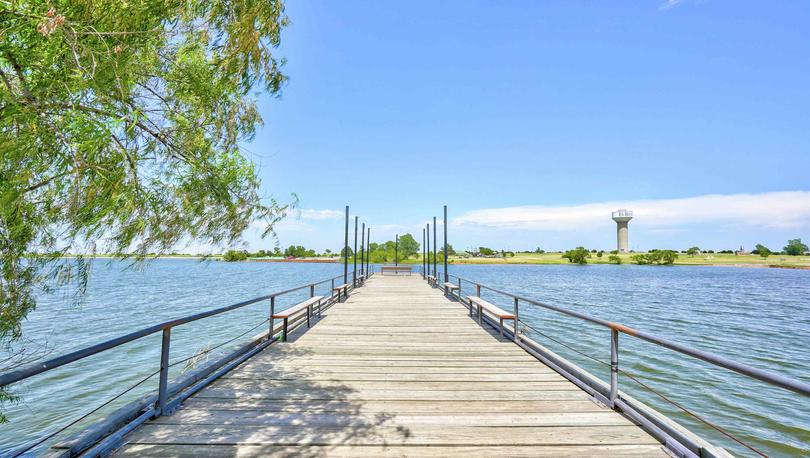 Crimson Lake Estates new home community dock with shade tree to fish off of