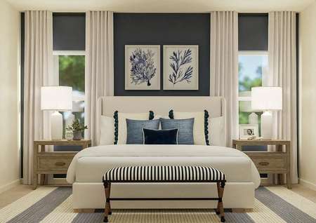 Rendering of the spacious master bedroom
  featuring a large bed centered between two windows. The room is also
  furnished with two nightstands, a bench at the end of the bed and a
  blue-and-white striped rug.