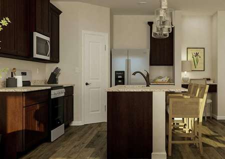 Rendering of the kitchen with brown
  cabinetry, stainless steel appliances and granite counters. A built-in desk
  is visible next to the kitchen.