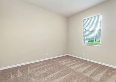 Carpeted, secondary bedroom with a window letting in plenty of natural light.