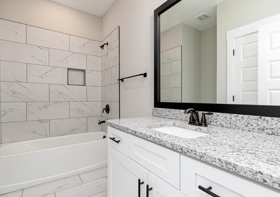 Secondary bathroom with a vanity and walk-in shower.