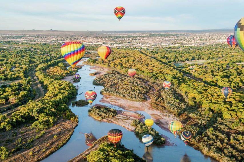 Hot air balloons floating over the Rio Grande near Albuquerque, New Mexico.