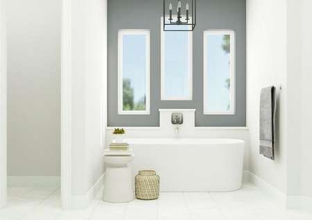 Rendering of the master bathroom centered
  on the freestanding bathtub. Above the tub are three windows letting in ample
  light and an elegant chandelier.