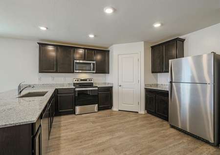 An incredible kitchen with an undermount sink, stainless appliances and sprawling granite countertops.
