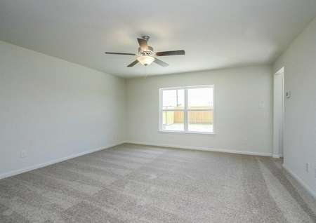 Trinity great room with carpeted floor, overhead ceiling light with fan, and white baseboards on gray walls