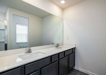 The master bedroom has its own full bathroom, which includes a double-sink vanity.