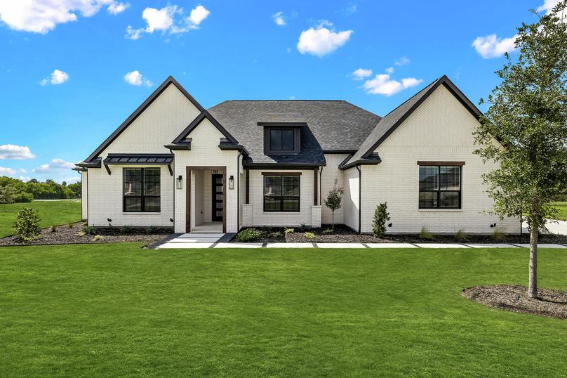 Stunning exterior of the Bradley with white brick and beautiful landscaping. 
