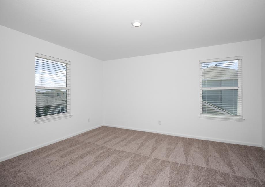 Guest bedroom with two windows and a large closet.