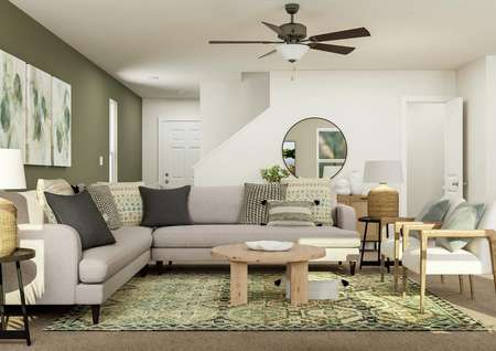 Rendering of the living room looking
  towards the front door. The space is furnished with a sectional, two chairs
  and coffee table.