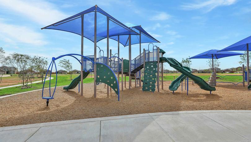 Children's playground with shading above playground equipment in Freeman Ranch community