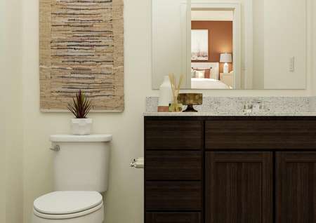 Rendering of the master bath with brown
  cabinet vanity and toilet. The shower is visible to the side and the attached
  bedroom is reflected in the mirror.
