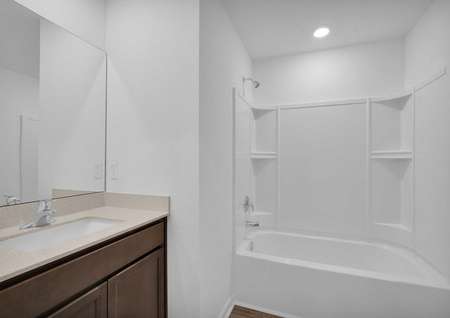 Full bathroom with a bathtub and plenty of countertop space. 