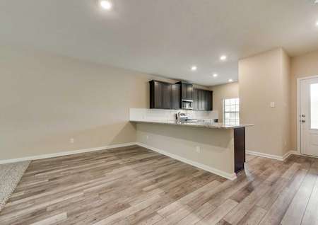 Tahoe dining room and kitchen with wood finish cabinetry and large window