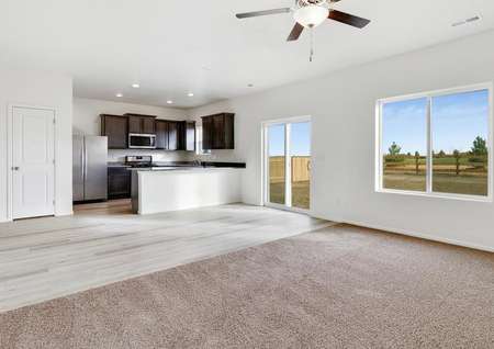 Open-concept layout, featuring a chef-ready kitchen, dining area, and sliding doors to the back yard. 