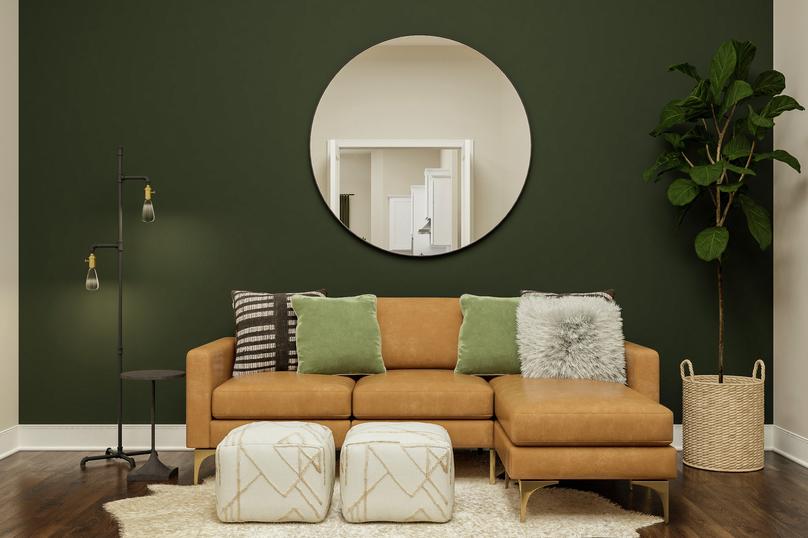 Rendering of sitting room showing tan
  couch along green accent wall and dark wood look flooring throughout.