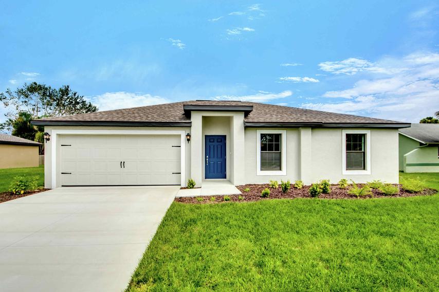 Front of the Vero floor plan renderings with a long driveway, a decorative two-car garage and a beautifully landscaped grass front yard.