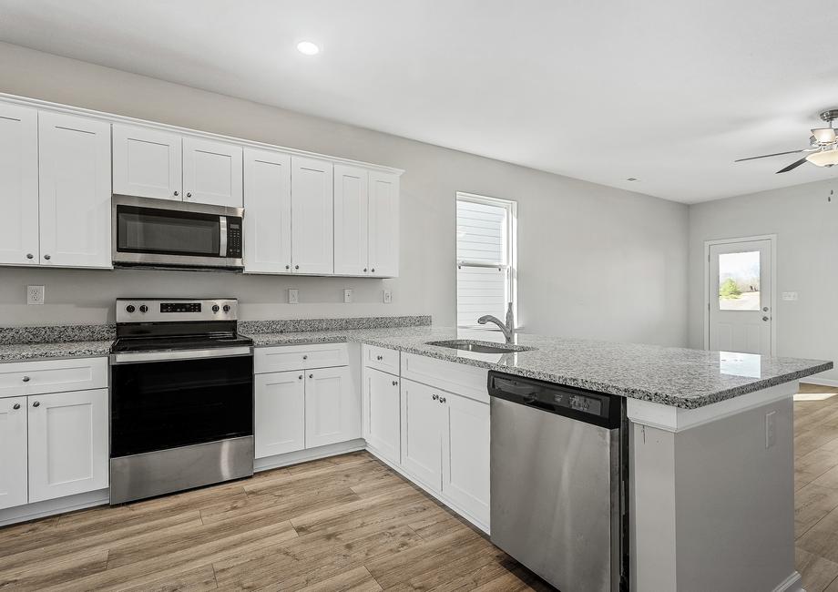 The kitchen has stainless steel appliances and granite countertops.