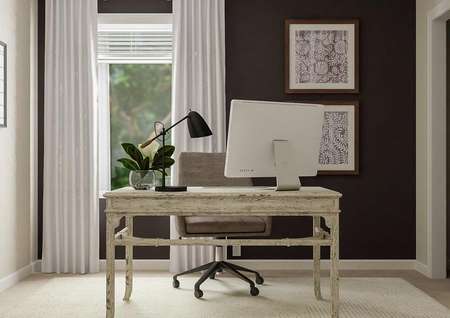 Rendering of a second bedroom decorated
  as an office with a desk. Behind the desk is a dark accent wall with a
  window.