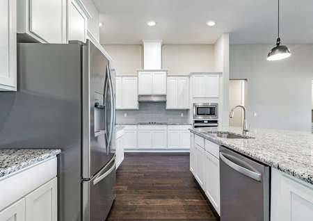 Impressive kitchen with wood floors, energy-efficient stainless steel kitchen appliances, white cabinets and granite countertops.