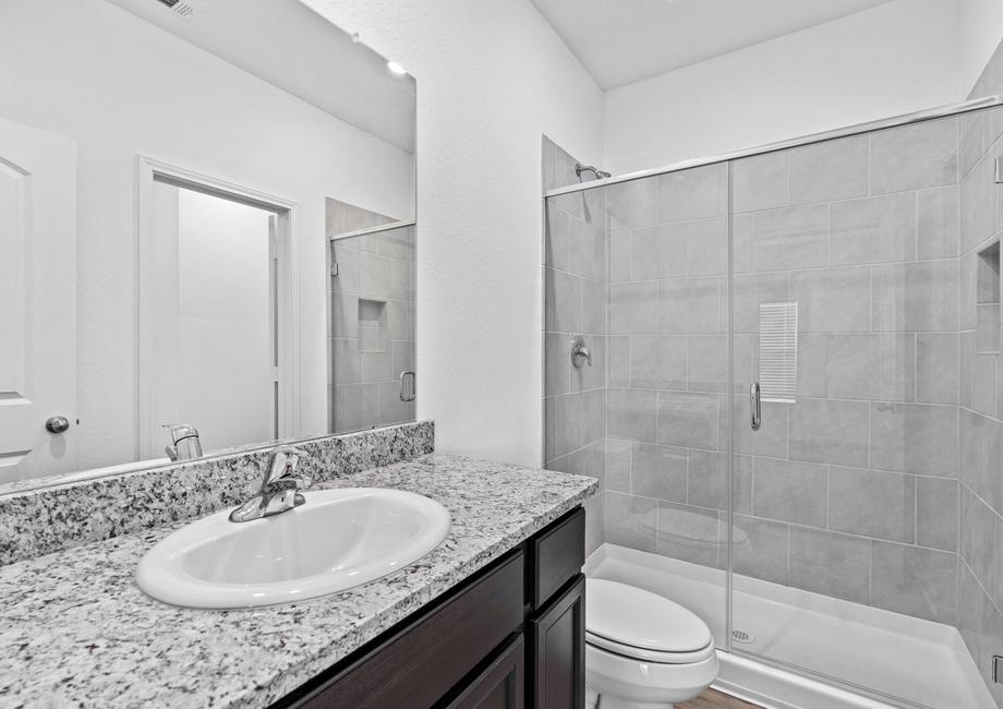 Master bathroom with a large walk-in shower lined with tile.