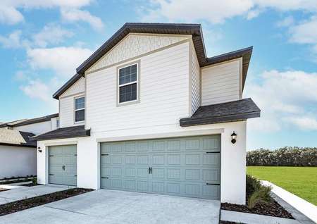 Angle view of townhome with a two-car garage and a side entry.