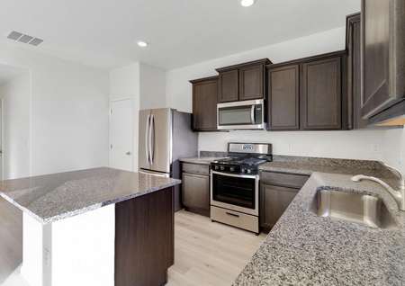 Chef-ready kitchen with granite countertops and stainless steel appliances. 