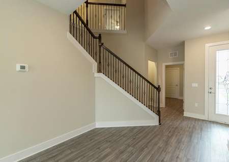 Foyer of two-story home with a beautiful stairway.
